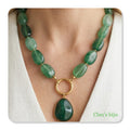 Necklace with green resin and steel pieces.