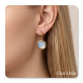 Steel earrings with opal stone.