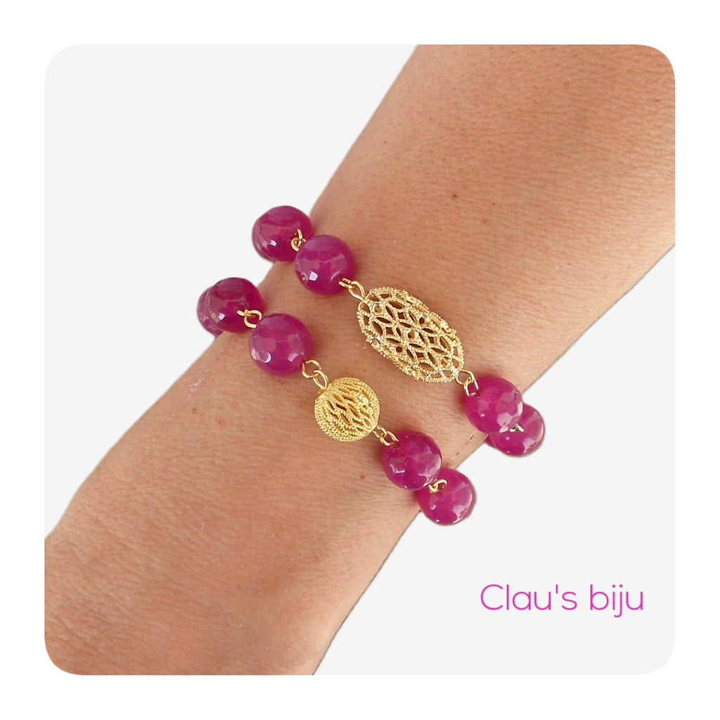 Necklace with pink stones and steel pieces.