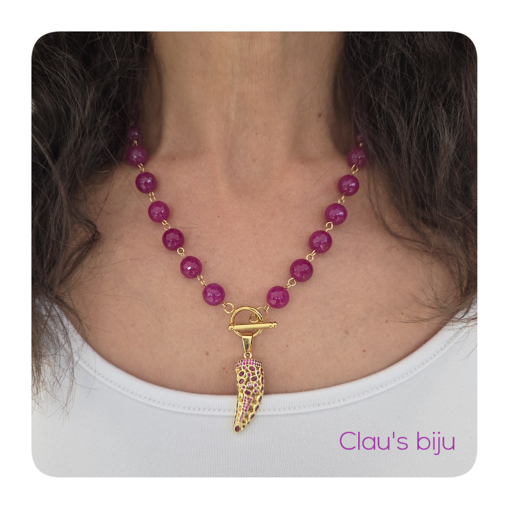 Necklace with pink stones and steel pieces.